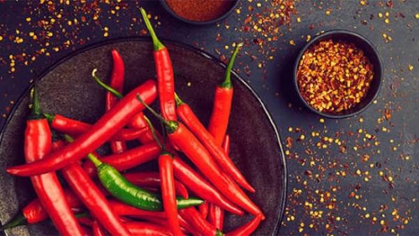 أطباق طعام حار مليئة بالفلفل الأحمر تعكس فوائد الأكلات السبايسي الصحية