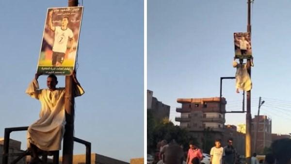 مشجع من كفر الشيخ يرفع صورة محمود صابر احتفالًا بعودة نجم منتخب مصر من كأس العالم 2026.