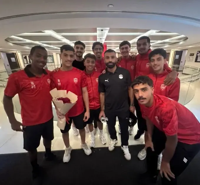 محمد صلاح يلتقط صورة تذكارية مع لاعبي أولمبي البحرين خلال المعسكر في الإمارات