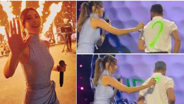 نانسي عجرم ترسم قلبًا على قميص أحد معجبيها خلال حفلها في الرياض.